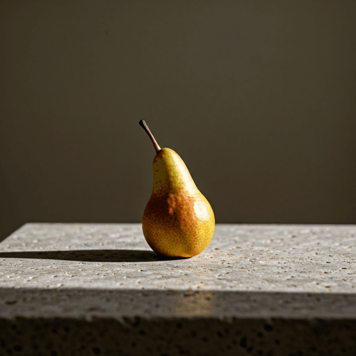 Still life of a single pear on a textured stone surface