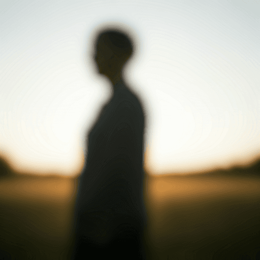 Blurred silhouette of a person in a field
